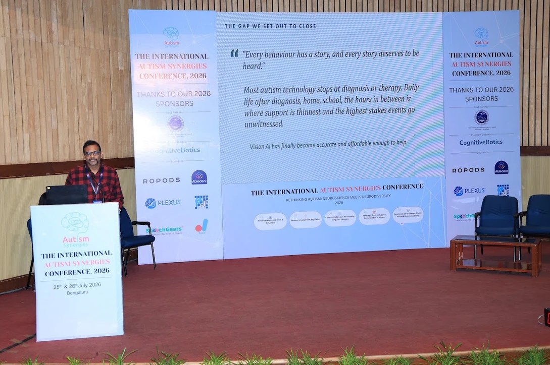 Ethan AI presentation slide reading every behaviour has a story, at the International Autism Synergies Conference 2026, NIMHANS Bengaluru
