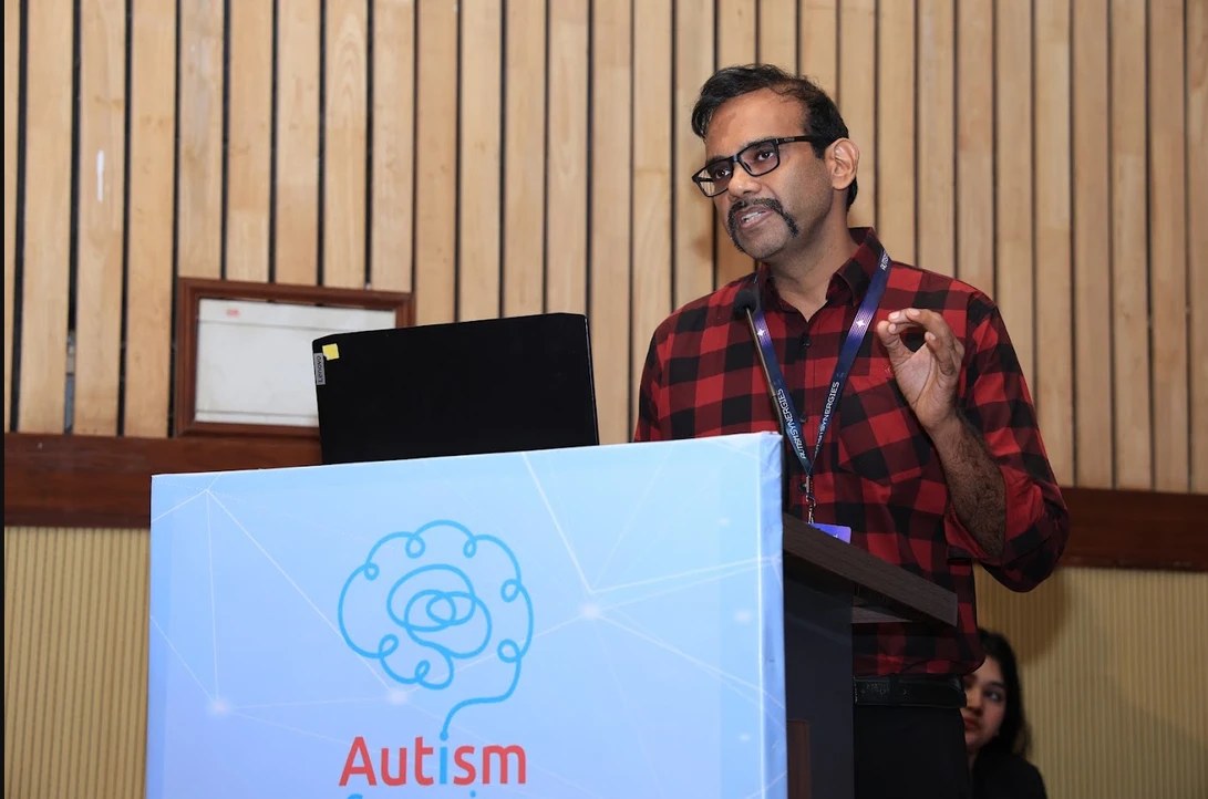 Pratush Charan presenting Ethan AI clinical results at Autism Synergies 2026, NIMHANS Bengaluru